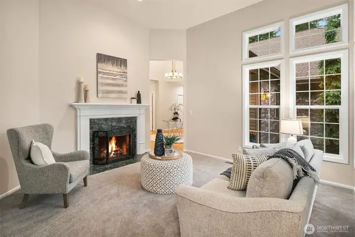 Formal living room with fireplace with gas starter.  Oversized, south facing windows flood this room with sunshine.