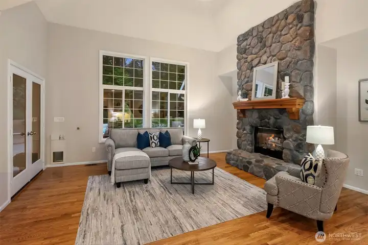 Hardwood floors throughout casual living space and tall windows let the sunshine in.