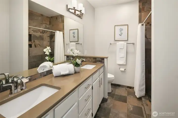 This bathroom features a walk in tile shower.