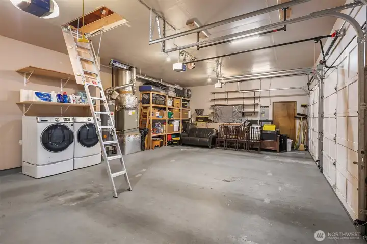 790sf 3-car garage with no center post!  Tons of built in storage. Extra tall garage doors.  Drop down ladder to huge attic storage space.