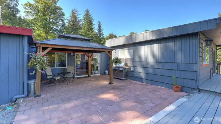 Charming gazebo offers shade and comfort for outdoor dining.