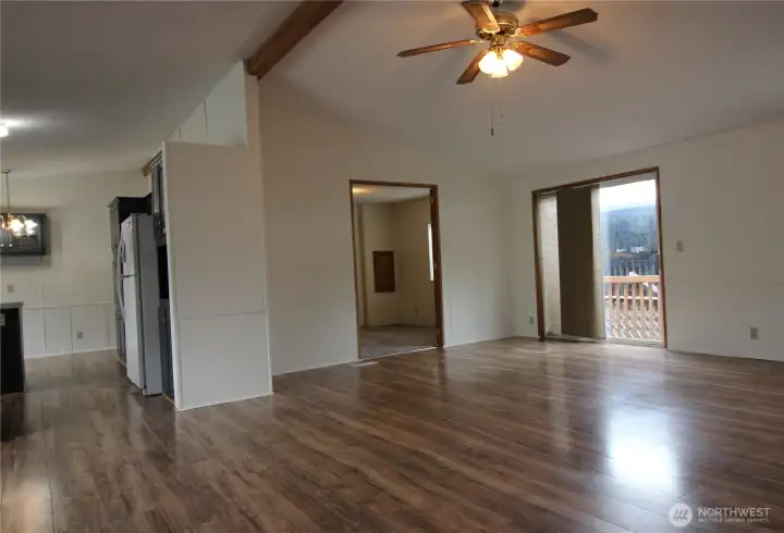 Walk into a large open concept living area with vaulted ceilings.