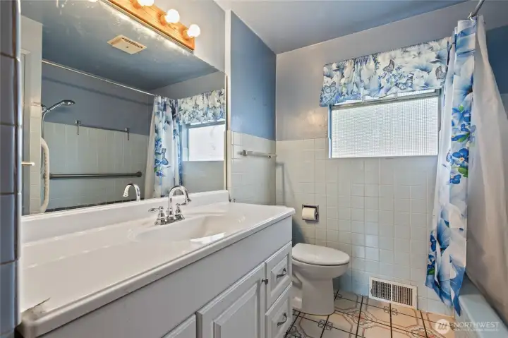 Full bath on the main that was updated in the 80's - it even has a blue tub.