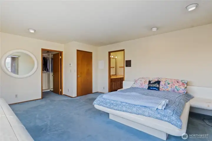 Large primary bedroom with original blue carpet
