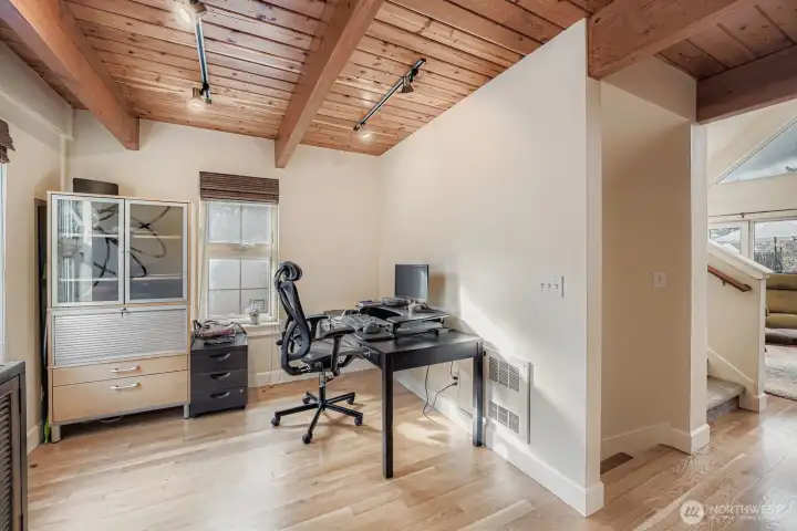 Eating space that is currently an office space with lots of natural light.