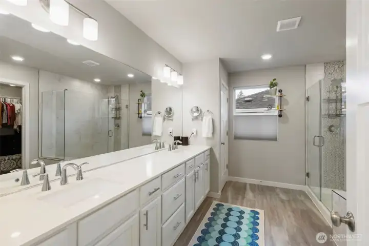 Primary ensuite bathroom with dual sinks and great storage