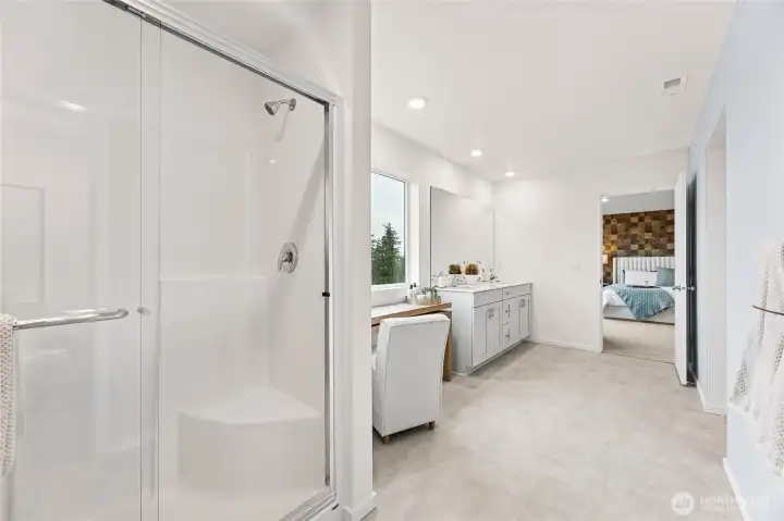 Primary bathroom features double vanity and step in shower. Photo is representational. Actual home is under construction and colors, materials, and finishes may vary. See site agent for details.
