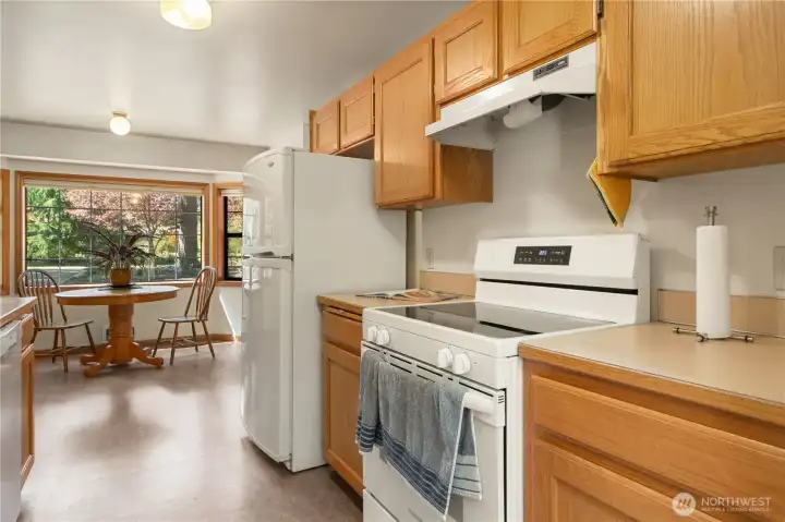 There is an additional dining area by the kitchen. Glass-top stove.