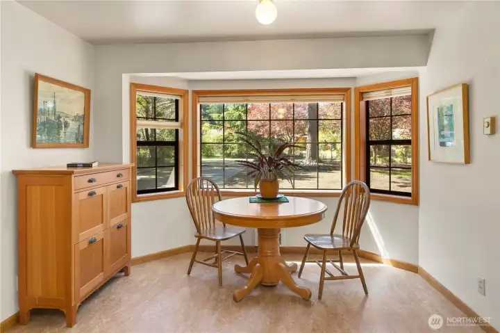 Bay window in the dining area provides a view out to the front yard and driveway. Not shown- door to the garage on the left.