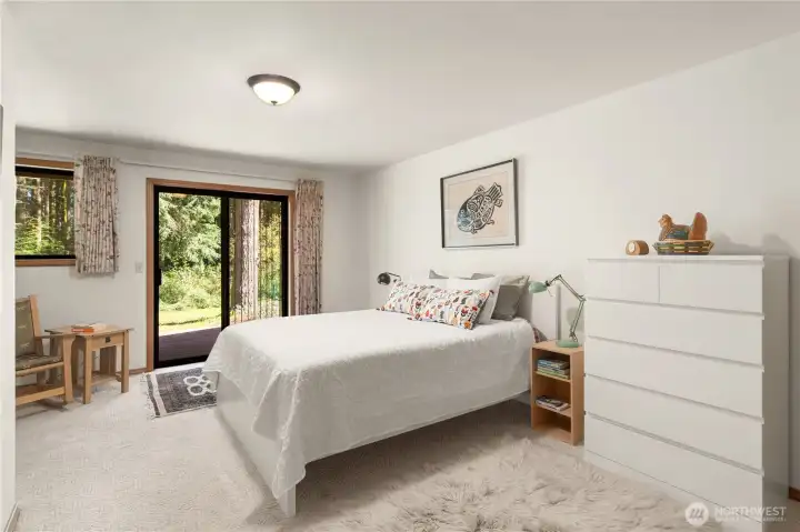 Primary bedroom has a sliding door to its own deck.