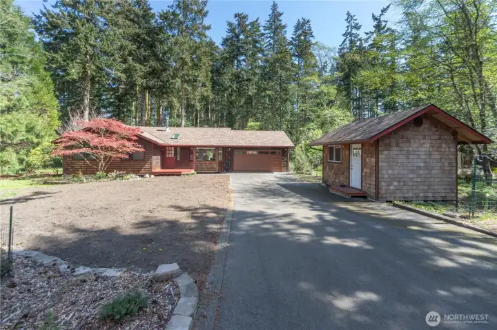 New asphalt driveway and a newer shed building.