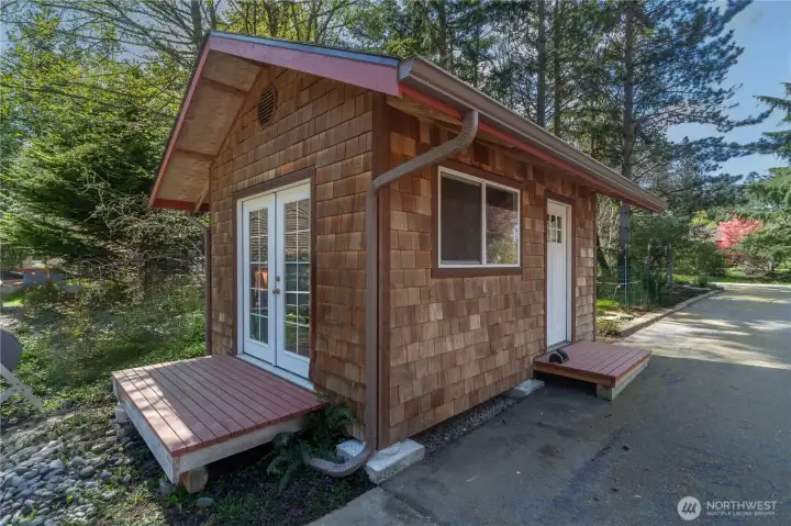 Shed has built-in shelves inside and has plenty of room for garden tools and more.