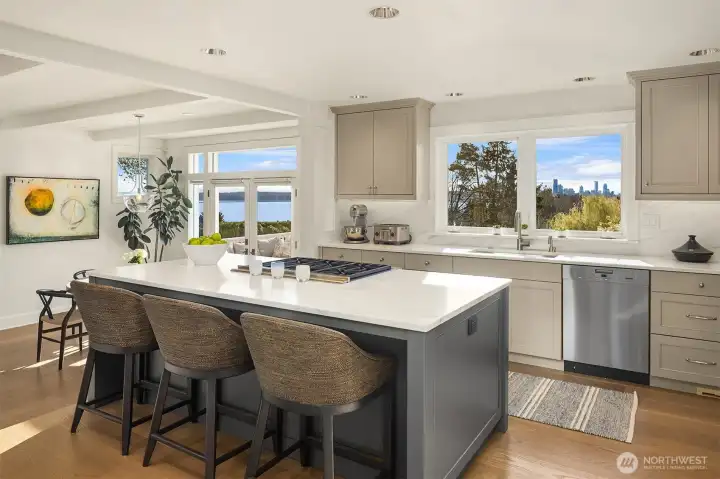 This kitchen was fully redone in late 2020- brand new custom cabinets, refrigerator drawers, beautiful slab marble and wide plank white oak floors.