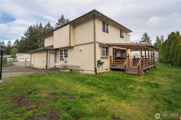 Rear yard with steps to the covered patio and rear man door to the garage