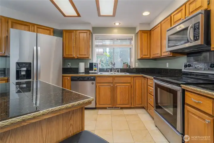 Beautiful kitchen with granite counter tops, marble floors