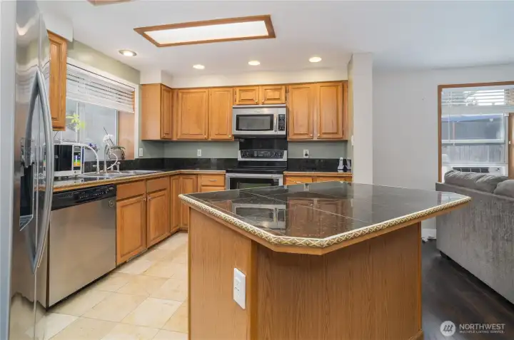 Open concept kitchen with family room and SS appliances