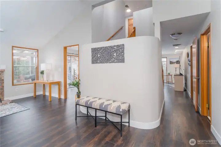 Vaulted living room and hall way leading to kitchen
