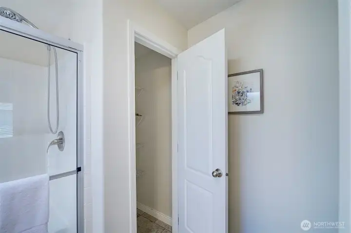 Primary bath with linen closet.