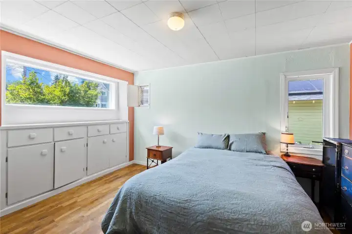 Primary bedroom on main level with custom built-ins. Primary bedroom on main level with custom built-ins.