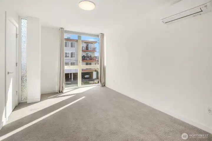 Upstairs, primary bedroom with ample natural light. Upstairs, primary bedroom with ample natural light.