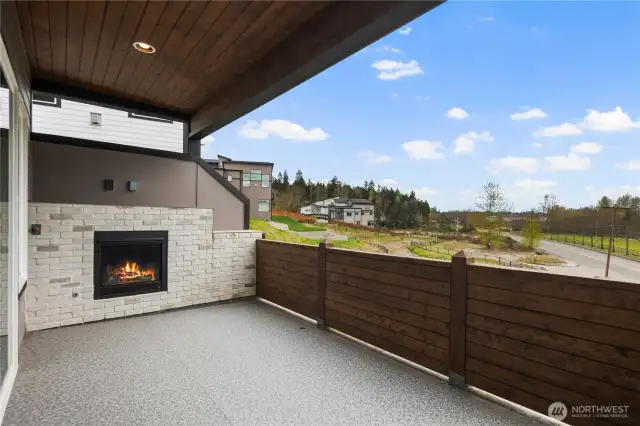 Covered Waterproof Deck w/Private Wood Railing & Stone Wrapped Gas Fireplace w/Views of River & Park