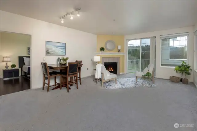 Spacious living room features a gas fireplace and private balcony that overlooks the greenery.