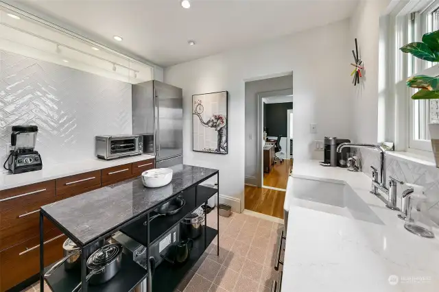 Kitchen has been remodeled with high end appliances, quartz counters, and new tile floors.