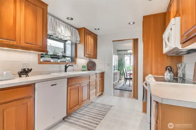 The kitchen features a garden window over the sink