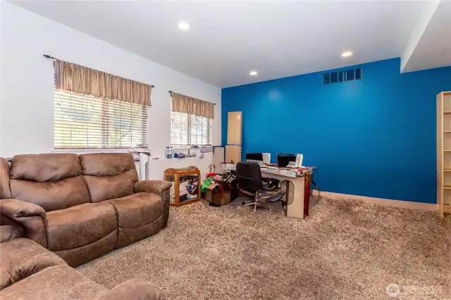 Opposite view of lower level family room with blue accent wall.