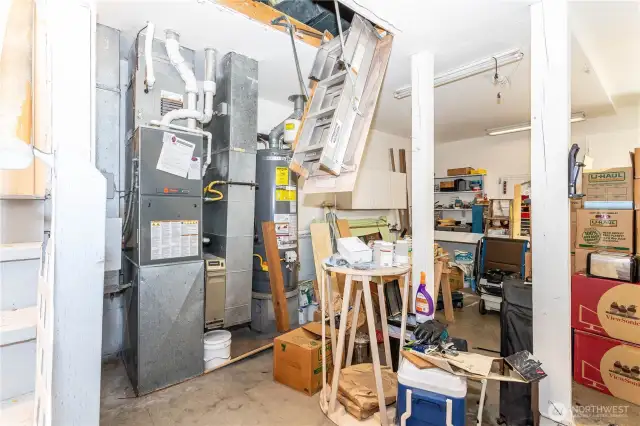 Handing down from garage ceiling is the attic stairs, which fold down to a full ladder. Storage is ample up there and ladder folds almost flush with the ceiling.