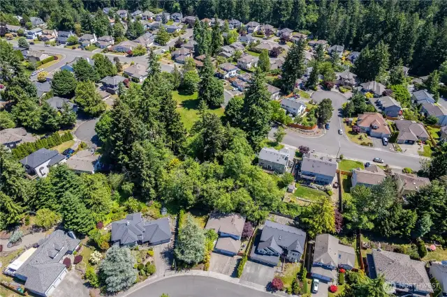 Drone footage of home with extensive private community park visible in its lushness. HOA dues maintain this, including its fence currently being replaced.