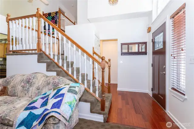 View of entry looking back from living room. Door to garage is visible at center back (to the right in the nook). Also a hall closet there next to stairs. Also the best view of stairs and landings, except if you view Matterport virtual tour.