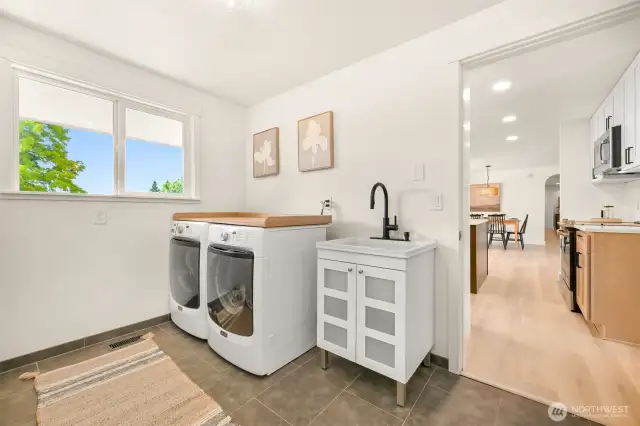 Huge laundry room with deep sink and lots of cabinets