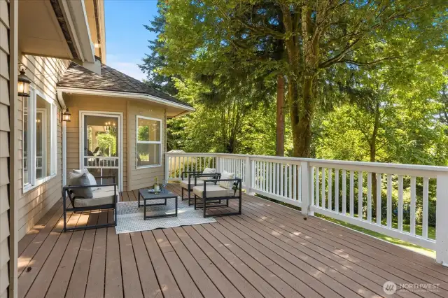 The deck features ample space for both dining and a comfortable sitting area, perfect for relaxing and soaking in stunning sunset views.