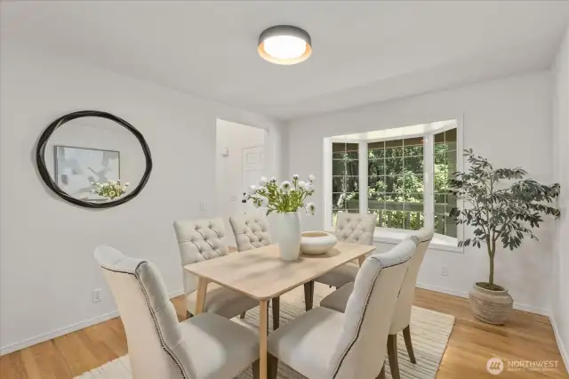 The formal dining room features stylish new lighting and offers flexible use—perfect as an elegant dining space or easily transformed into a main floor office or cozy sitting room to suit your lifestyle needs.