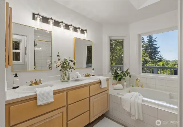 The primary bath is beautifully updated, featuring dual sinks, a jetted bathtub with a relaxing view, a separate shower, and a private water closet. New lighting, mirrors, flooring, and fresh paint complete this serene and stylish retreat.