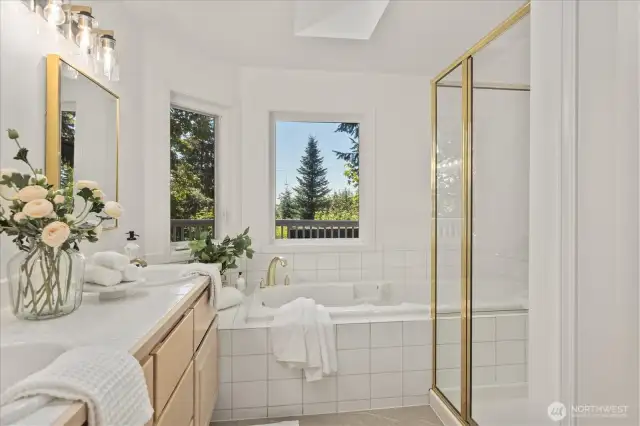Enjoy the jetted tub surrounded by private windows that frame tranquil views, allowing you to soak in the scenery while enjoying peaceful natural light and a sense of privacy.