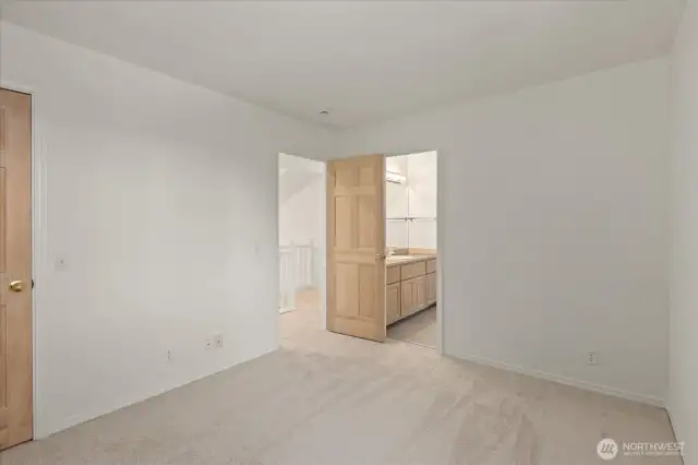 The second-floor 2nd bedroom features plush new carpet, fresh paint, and an adjoining bathroom, creating a comfortable and ready-to-enjoy space for family or guests.