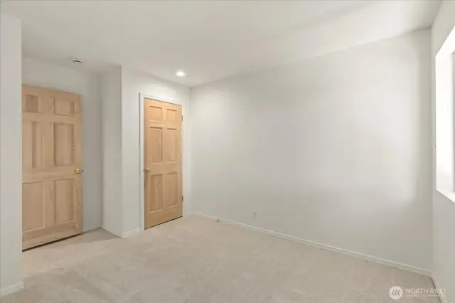 The third bedroom boasts a spacious walk-in closet, secret attic access, and shares an adjoining bathroom with the second bedroom. Fresh paint, new carpet, and updated lighting complete this bright and inviting space.