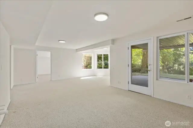 The lower-level rec room offers level access to the backyard, creating a seamless indoor-outdoor flow. Just a few steps away is a private parking area, making this space ideal for a potential ADU or versatile living area.