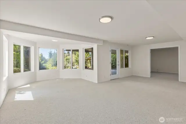 The lower level includes space for a second dining area and rough-in plumbing for a second kitchen, providing excellent potential for an ADU or multi-generational living setup.