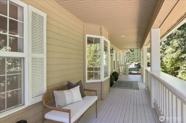 The charming front door entry opens onto a covered, shaded deck that invites you to relax while enjoying peaceful views of the beautifully landscaped gardens.