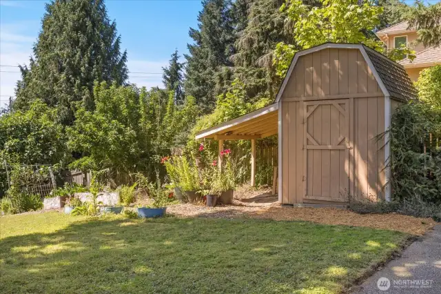A large garden shed provides ample storage space for tools, equipment, and gardening supplies, keeping the outdoor areas neat and organized.