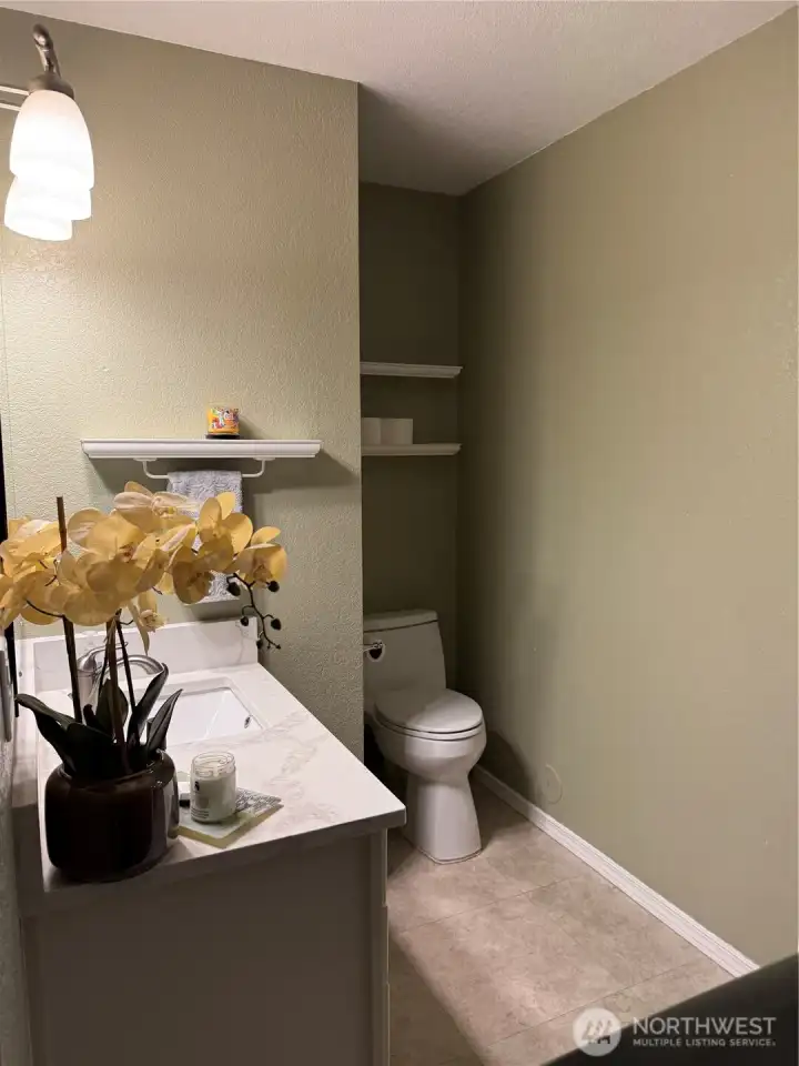 1/2 bathroom located off kitchen with full laundry