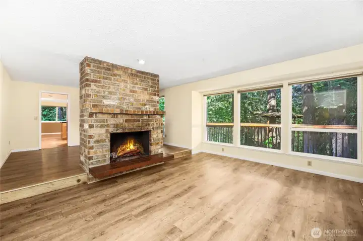 Brick faced wood burning fireplace with mantle & tile hearth  Recessed light above fireplace