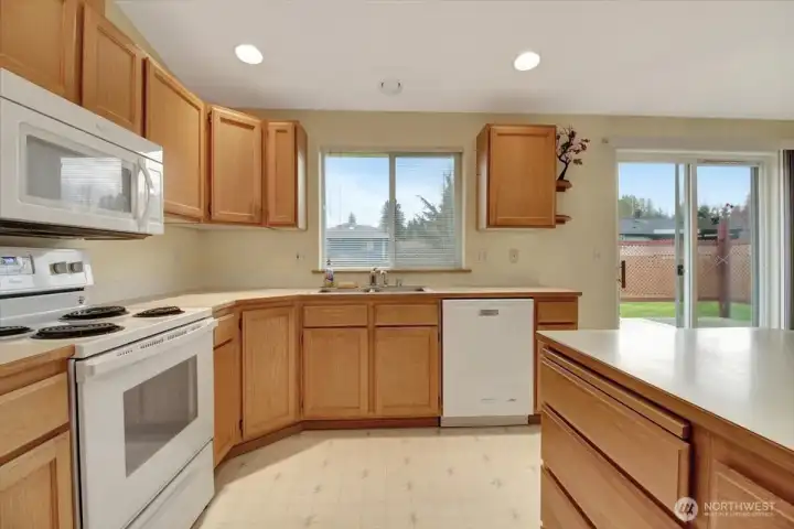 Kitchen with abundant lighting and cabinets
