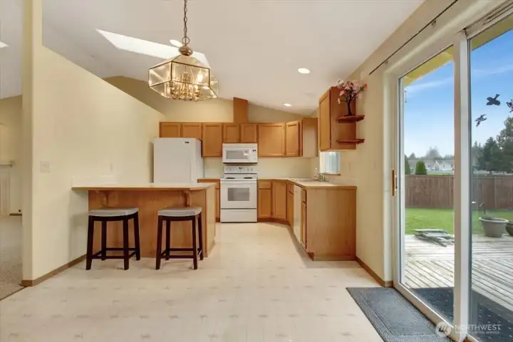 View of Kitchen, breakfast bar and patio slider to rear deck