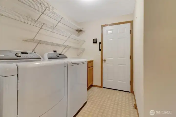 Utility room with room for freezer to right accessing garage