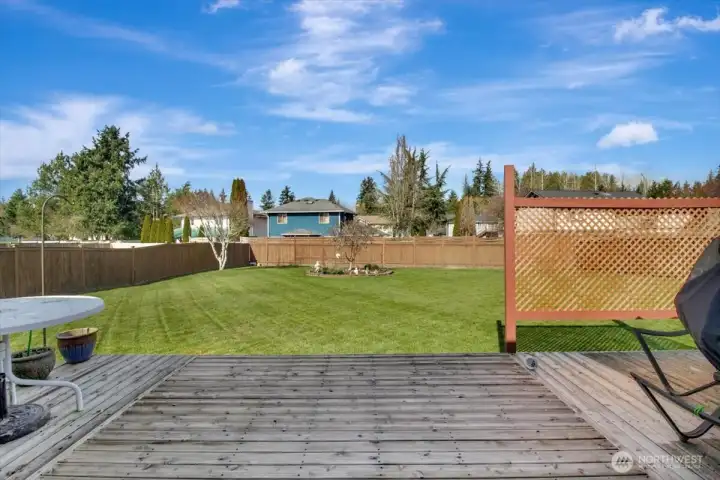 View of yard from rear deck looking north. Fully fenced back yard