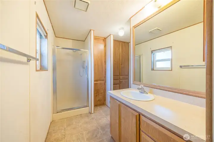 Large primary bathroom is large and features a shower and a separate water closet